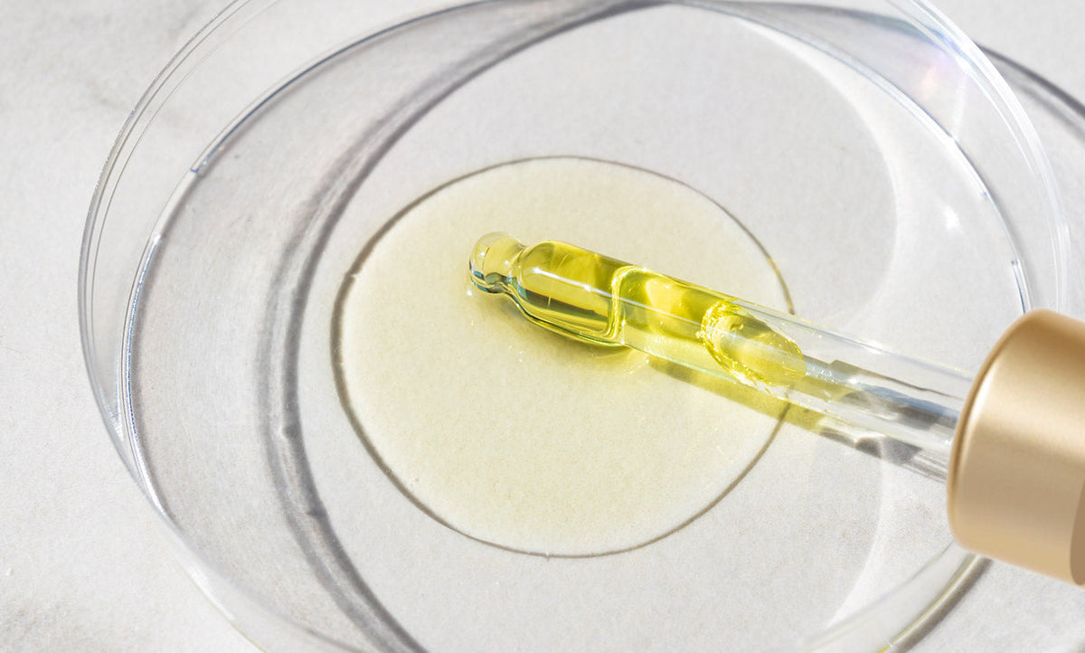 Vitamin C in a petri dish being pulled by glass dropper
