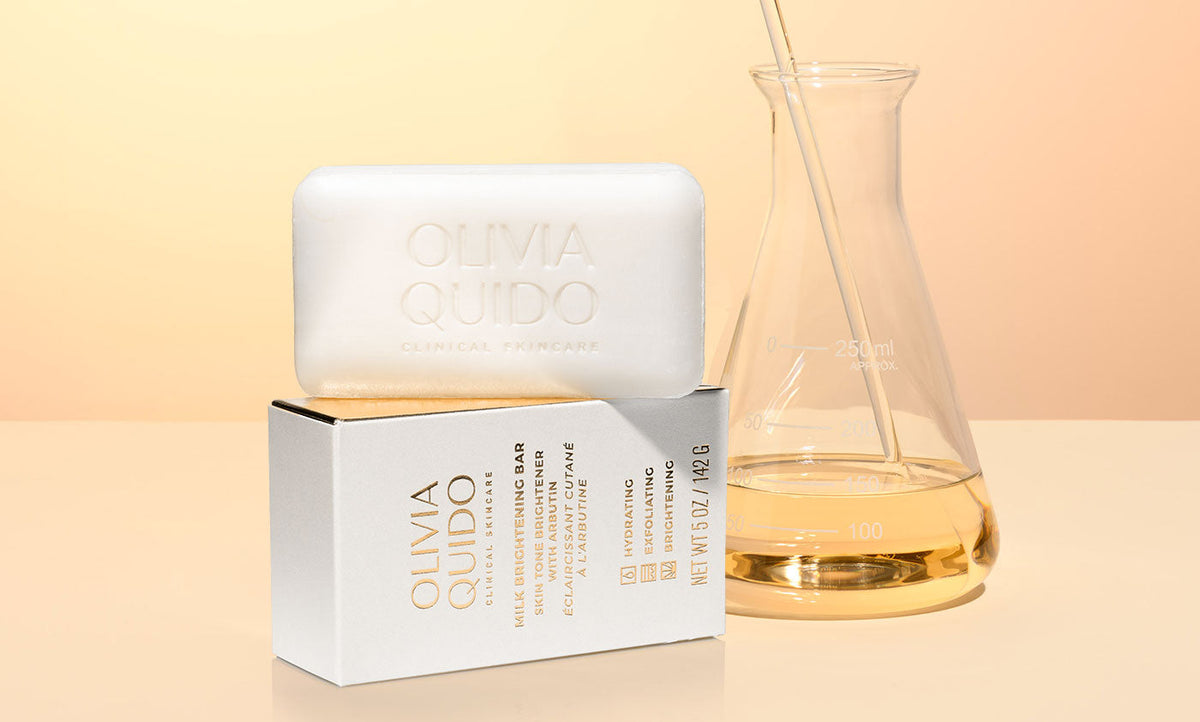 Milk Brightening Bar next to lab glass