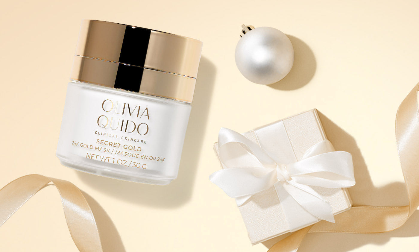 Olivia Quido Clinical Skinare Secret Gold 24K gold face mask on a gold background with ornaments and packages
