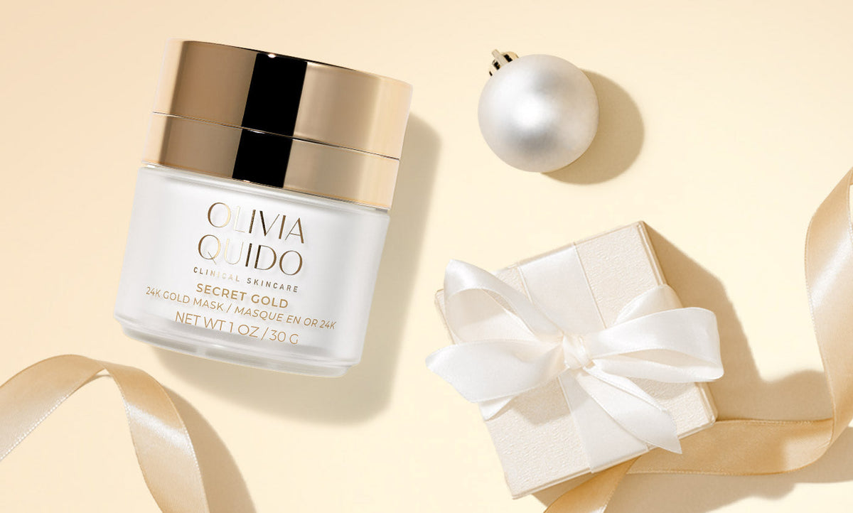 Olivia Quido Clinical Skinare Secret Gold 24K gold face mask on a gold background with ornaments and packages