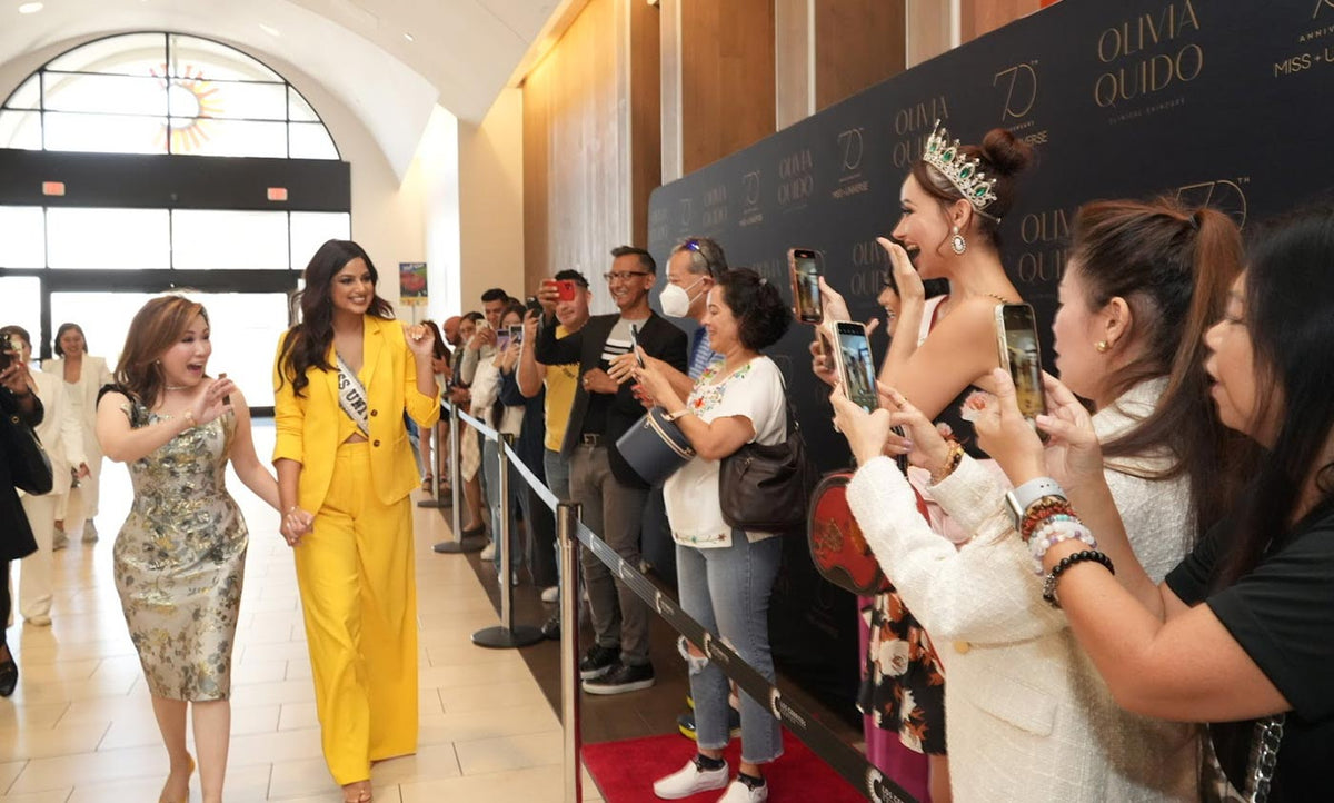 Olivia Quido walking with Miss Universe winner
