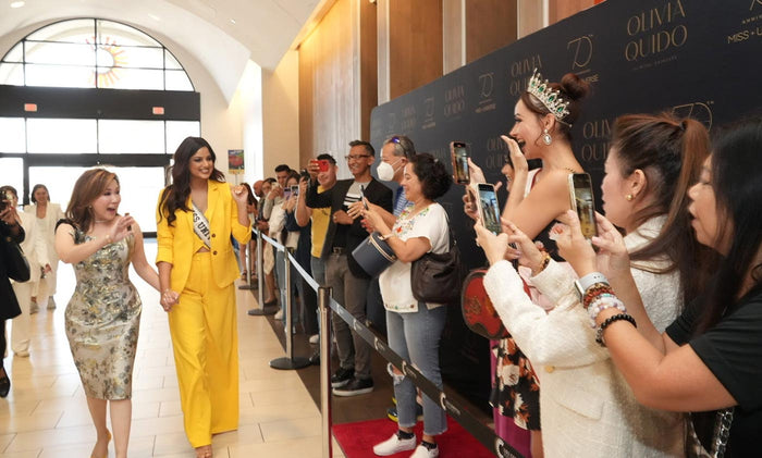 Olivia Quido walking with Miss Universe winner