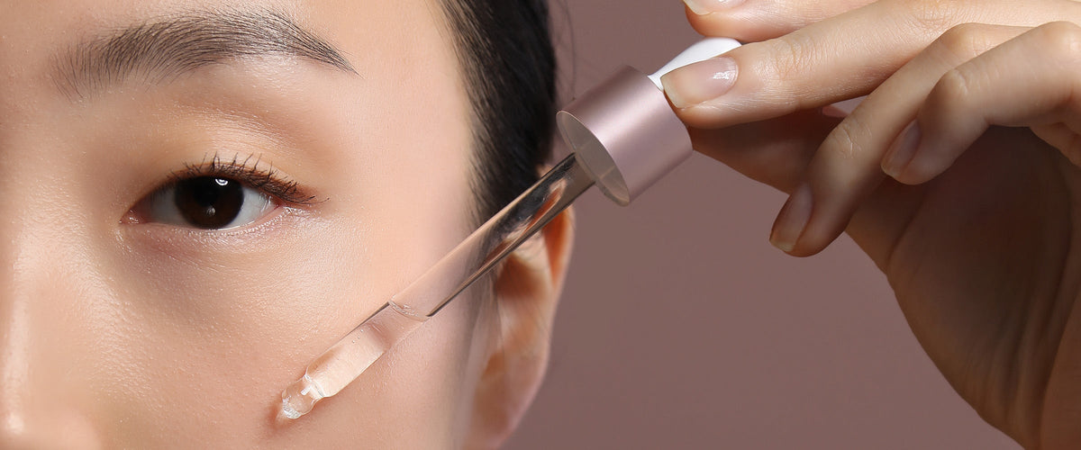 Woman applying Beauty Oil  with Bakuchiol