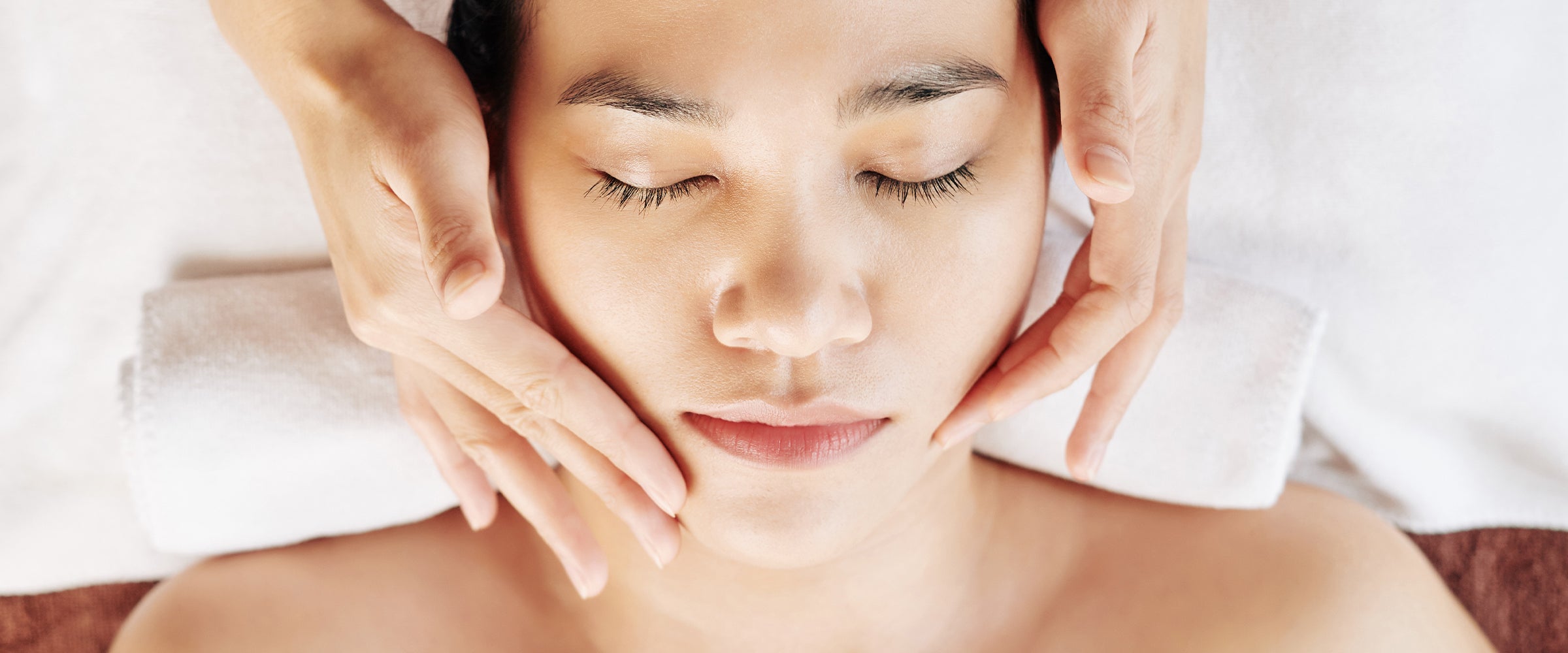 Woman receiving facial treatment