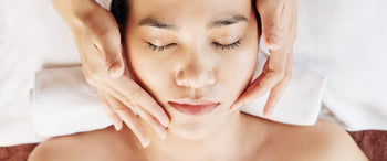 Woman receiving facial treatment