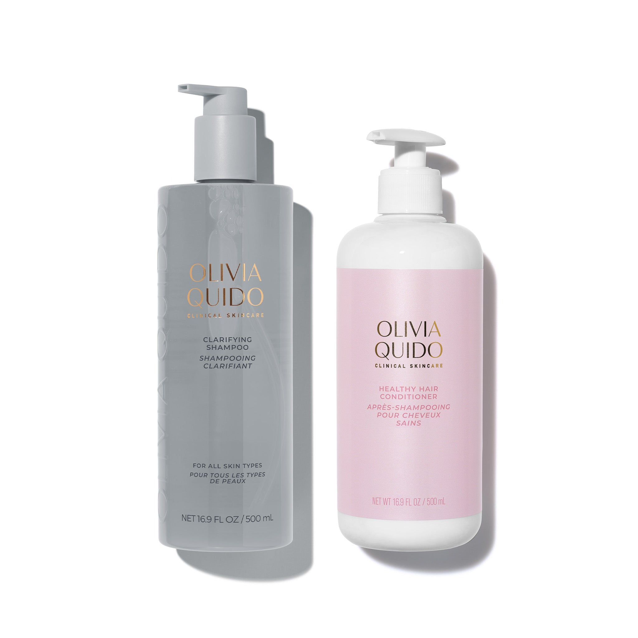 Healthy Hair Conditioner by Olivia Quido in a pink bottle alongside Clarifying Shampoo in a grey bottle.