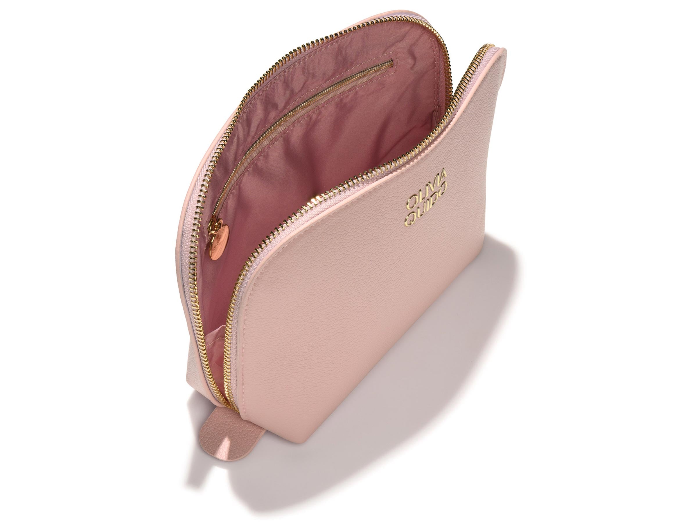 Olivia Quido Faux Leather Dome Cosmetic Bag showing the interior design in soft pink color.